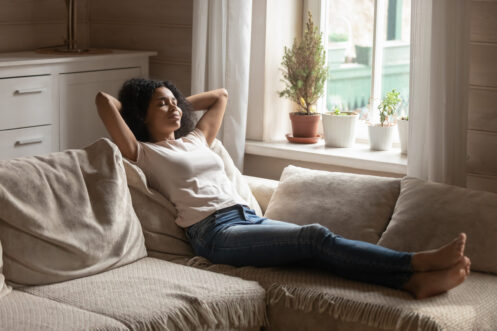 A young woman relaxing in her home in St Charles